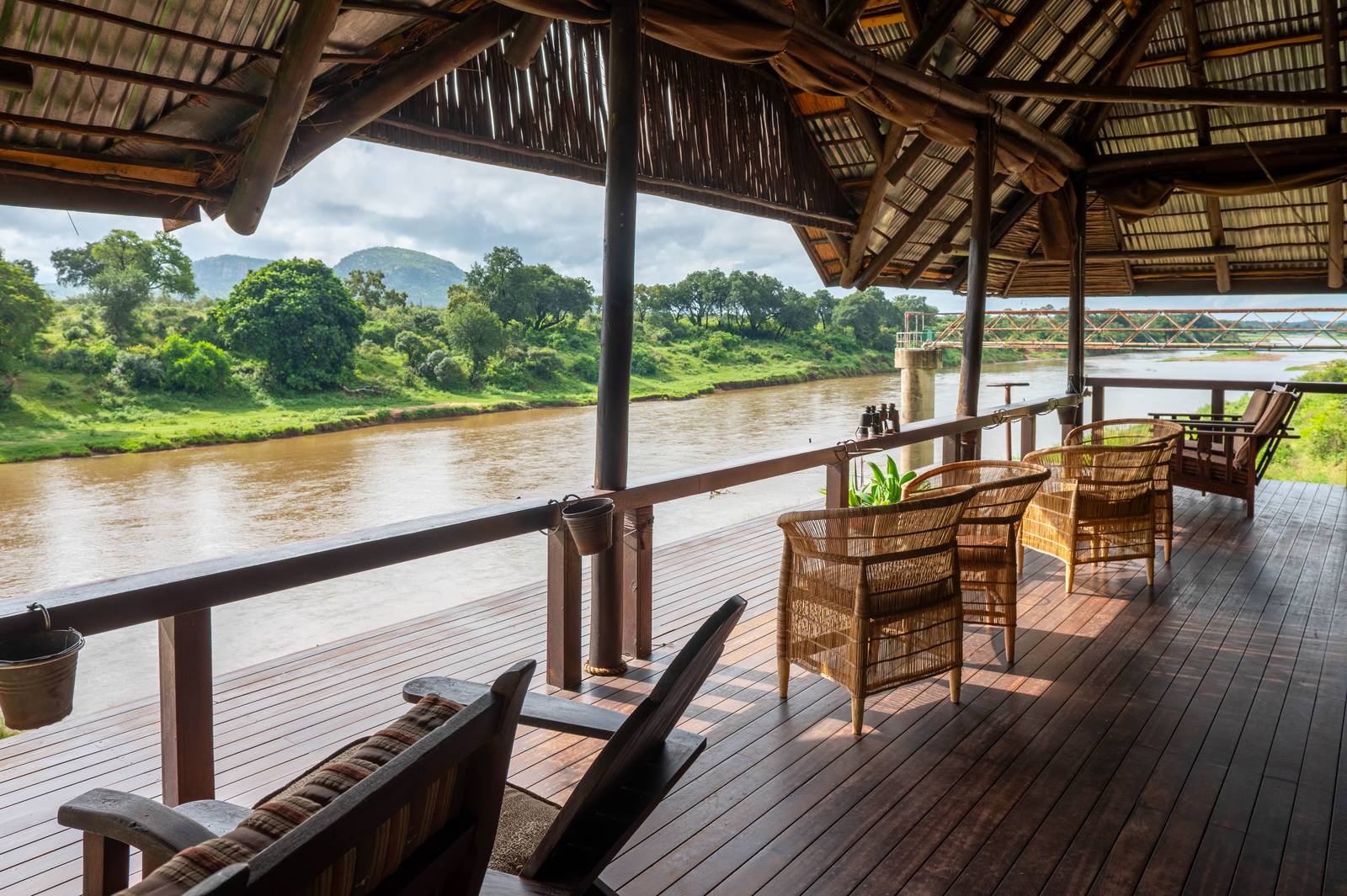 Thatched riverside deck at River House Lodge overlooking the Crocodile River