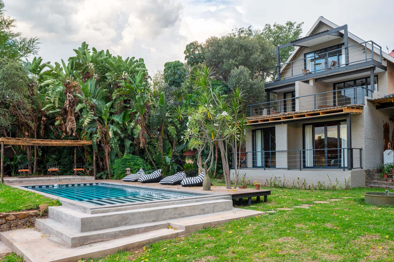 Lodge building and garden pool among tropical palms
