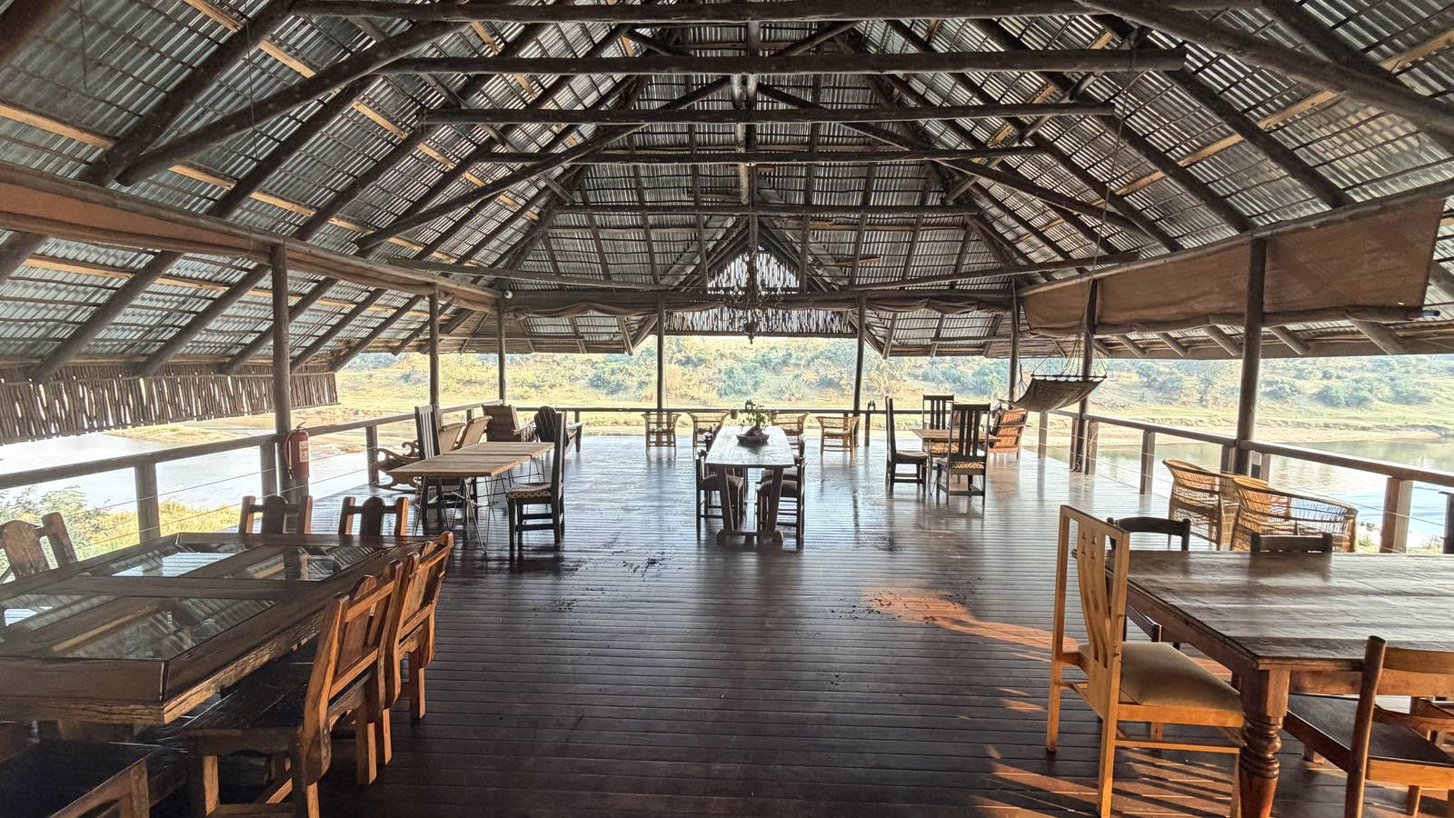 Large covered deck with tables overlooking the Crocodile River
