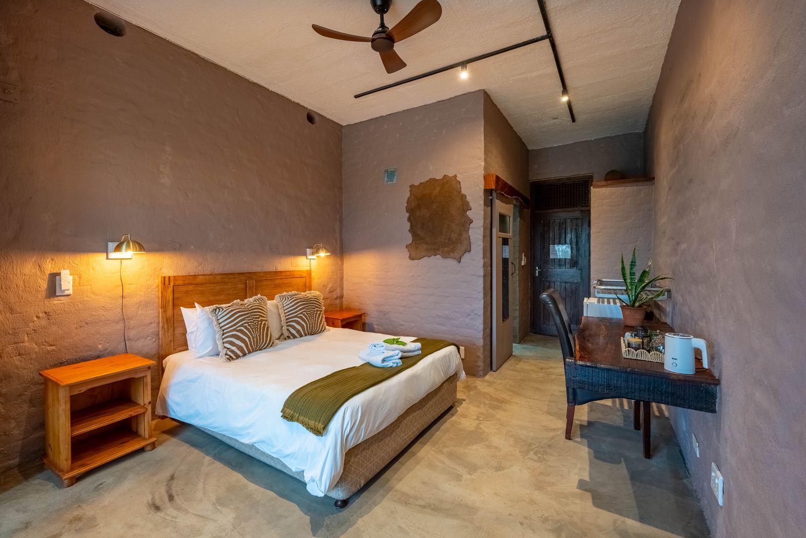 Guest room with queen bed and warm lighting
